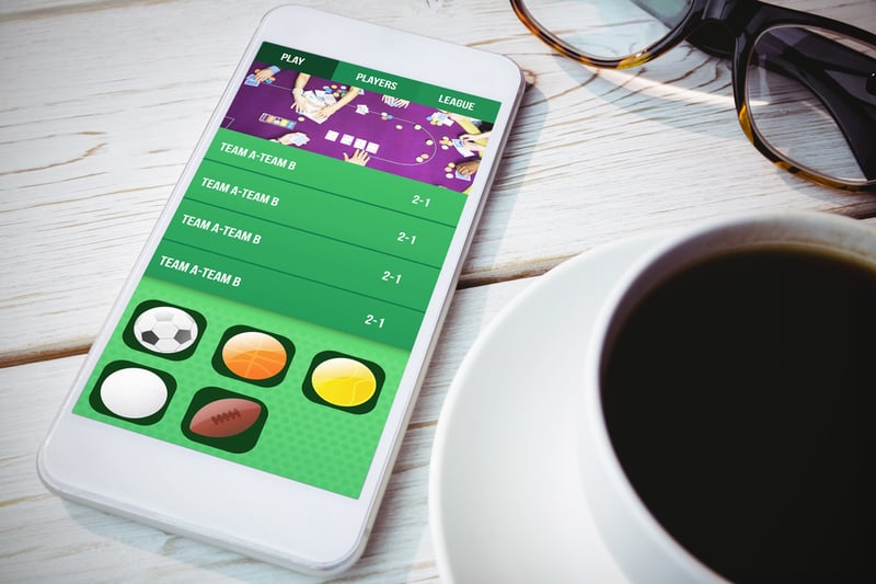 Gambling app screen against smartphone on table
